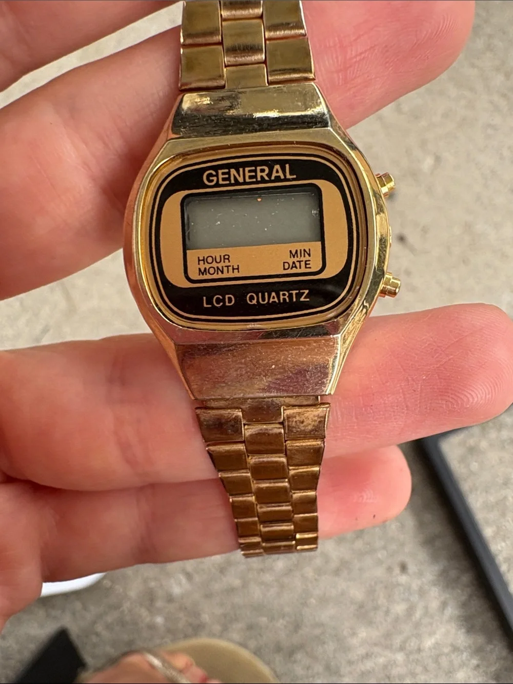 retro digital display and linked metal band typical of 1980s timepieces.